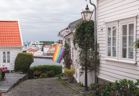 colorful rainbow flag in the white house on the street of the old town of Stavanger, Norwayの写真素材