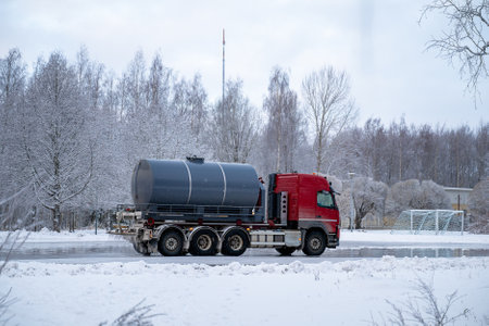 water truck sprays water in winter and makes a skating rink in the yardの写真素材