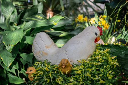Handmade decorative chicken figure in garden setting. Spring and Easter symbol