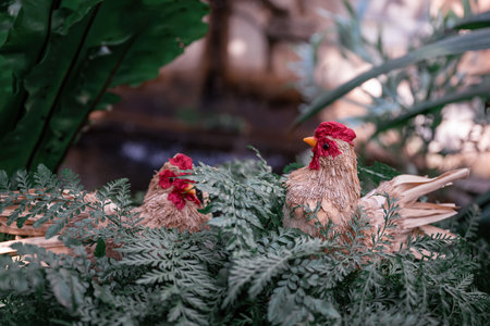 Handmade decorative chicken figure in garden setting. Spring and Easter symbolの写真素材