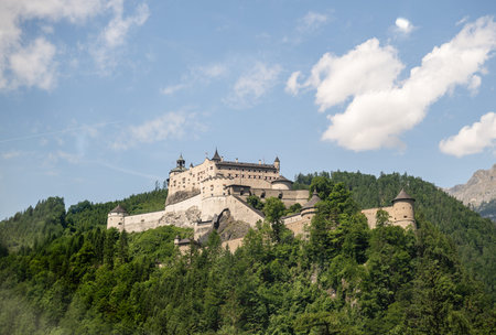Medieval fortress Hohenwerfen Castle on green forested hill in Austrian Alpsの写真素材
