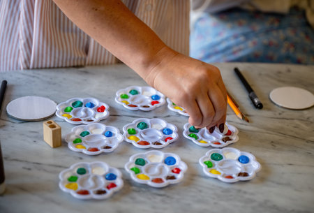 Colorful paint palettes with brushes and pencils on marble table ready for art activityの写真素材