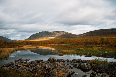 Autumn landscape with lake reflection and mountain view in Kilpisjarvi Finlandの写真素材
