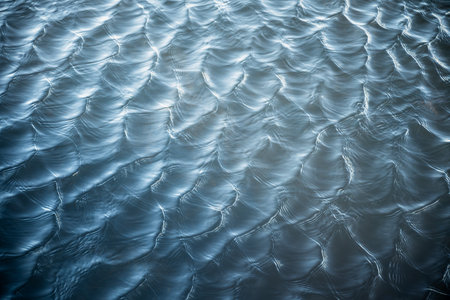 abstract water surface with soft ripples and light reflectionsの写真素材
