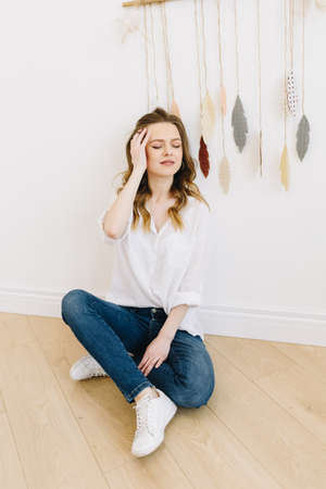 Vertical image of beautiful young caucasian woman sittingの写真素材