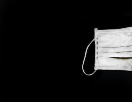 Banner with copy space for text of protective medical face mask isolated on deep black backgroundの写真素材