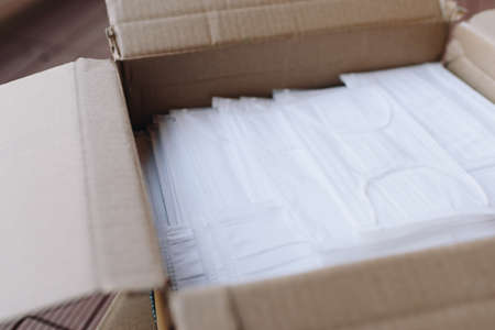 Top view of opened box of surgical face masks, corona virus covid 19 global pandemicの写真素材