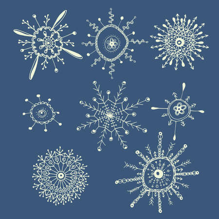 Set of 8 hand drawn strange white snowflakes isolated on a blue background. Traditional xmas and new year decoration elements for creative design.のイラスト素材