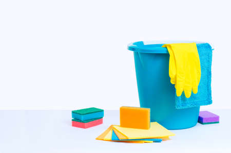 Front view with white background. Blue bucket, sponges, gloves and rags.の写真素材