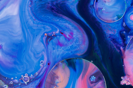 Abstract patterns made by paint, milk and soap.の写真素材