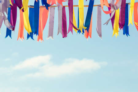 Colorful bunting party flags in a sunshine day. Clouds on the backgroundの写真素材