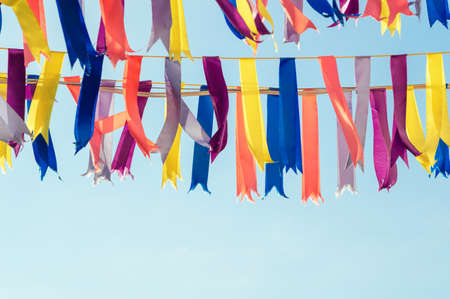 Colorful bunting party flags in a sunshine day. Blue sky on the backgroundの写真素材