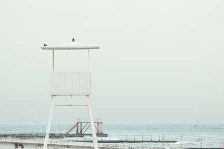 A white wooden lookout lifeguard tower. Seascape in soft vintage tonesの写真素材