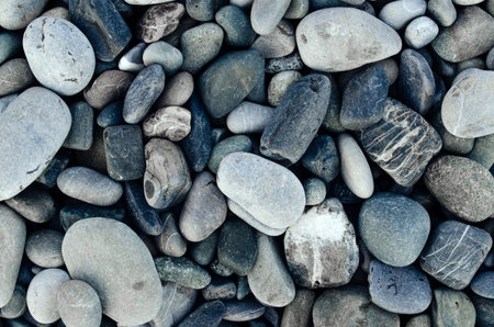 Gray stones close-up. Minimalistic beautiful background in gray tones. Pebble beach.