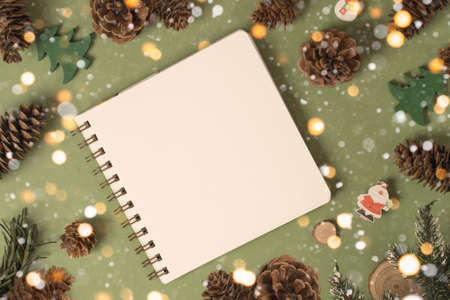 A beautiful New Years flatlay with a notebook for notes, lights and snowの写真素材