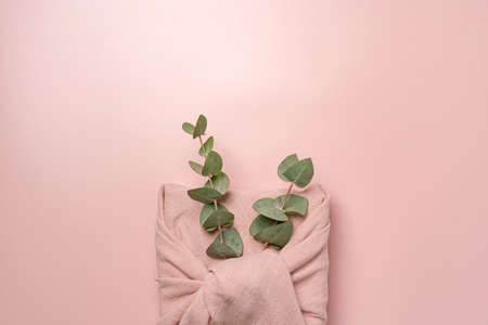 cute beautiful pink gift wrapped in cotton, on a pink background close-up view from aboveの写真素材