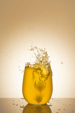 beautiful splashes in a glass with orange juice. High quality photoの写真素材