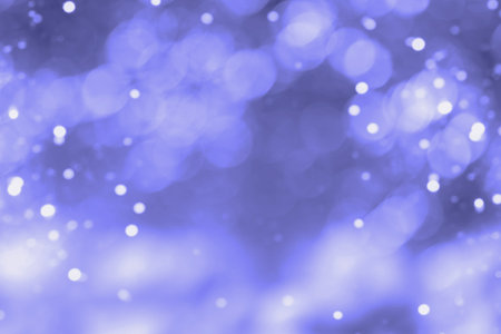 abstract background with beautiful bokeh tinted in the color of the year 2022, Very Peri. High...
