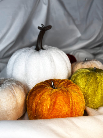 Set of fabric textile pumpkins on a white textile background. Top view. Halloween handmade pumpkins, sewing.の写真素材
