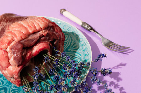 Top view of animal heart filled with lavender flowers on turquoise plate. Creative love, St Valentine holiday, concept.の写真素材