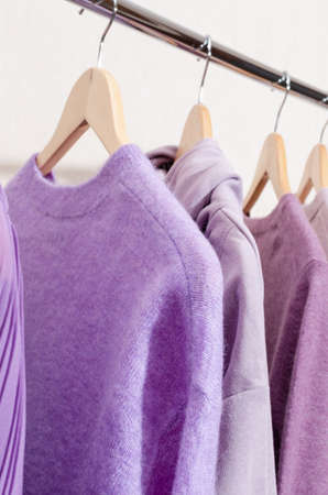 Closeup of fashionable tops in trendy purple, very peri, lavender colors on a shopping rail.の写真素材