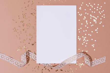 Mockup, invitation, greeting card with golden sequins on a beige paper background. St Valentine, Mothers Day, wedding.の写真素材