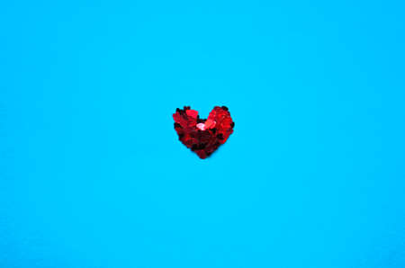 Shiny hearts are a symbol of love. The heart of small hearts on a blue background. Creative ideaの写真素材