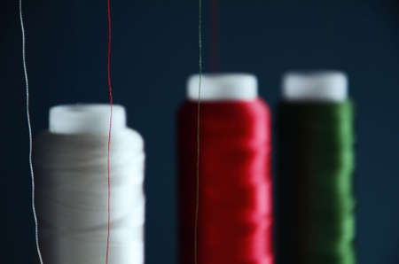 threads in blue colors on the background of a sewing machineの写真素材