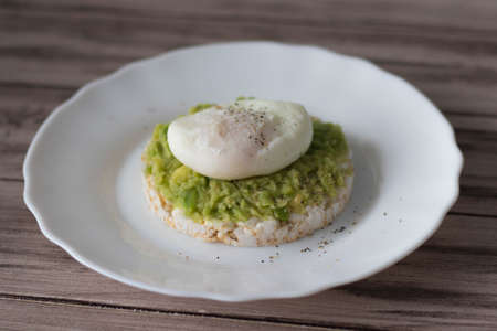 Poached eggs on bread with avocado and pepperの写真素材