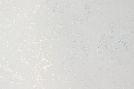 Background texture of white paper with glitter.