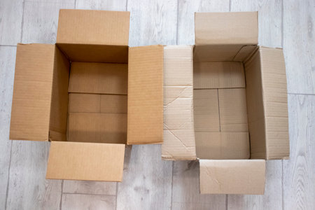 Two empty open boxes on the floor