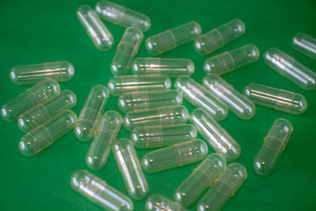 Empty Capsule Pill on a Bright Green Background