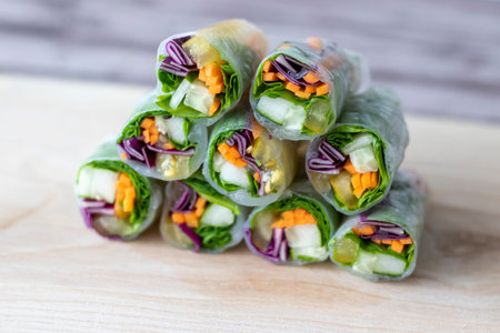 Vegan vegetable spring rolls in rice paper macro photo, selective focus.