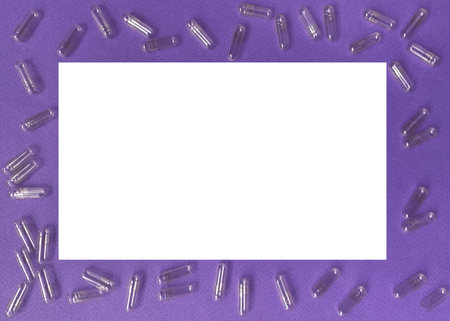Lilac frame with empty capsules for pills, vitamins and supplements. Frame with white space for text