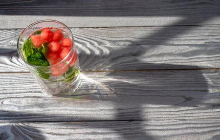 Fresh summer cocktail watermelon juice in a glass of gray background. Layout for a wide banner with room for text.の写真素材