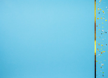 Blue texture paper sky color background with gold ribbon and round sequins, glitter, sequinsの写真素材