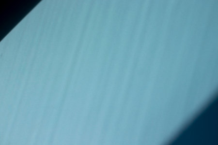 Blue textured paper background with shadows. Copy space for text. Flat lay, top view, copy space. Design for text.の写真素材