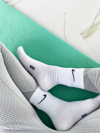 IRPEN, UKRAINE, SEPTEMBER 23 20222, Nike socks on a woman doing yoga, Illustrative Editorial.のeditorial素材