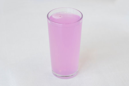 An effervescent tablet of electrolytes with vitamins for athletes dissolves in a glass of waterの写真素材