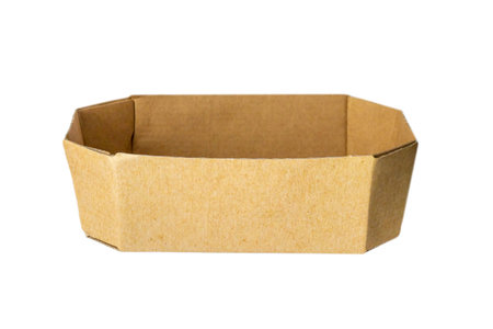 Brown isolated cardboard box on white background. Octagonal brown basket box without lid side view.