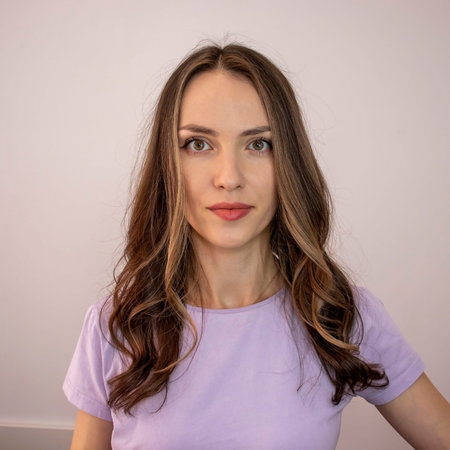 Beautiful young woman with fashionable partially bleached hair in a pastel purple t-shirt.