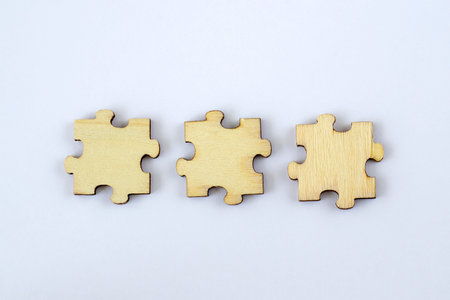 Mock up of three blank wooden puzzles on a white background for your abbreviation text or design.