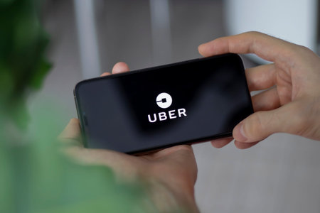 IRPEN, UKRAINE - JANUARY 20 20223, Closeup of smartphone screen uber lettering with in mans hands,...