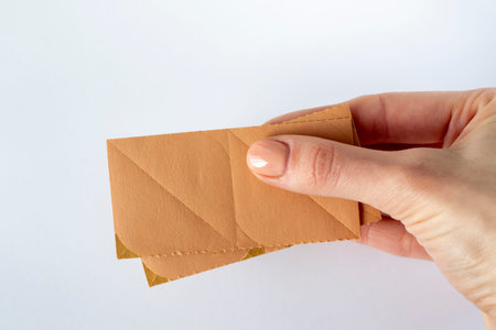Beige wrinkle face stickers on a white background in a womans hand. Discover the Secret to Youthful...