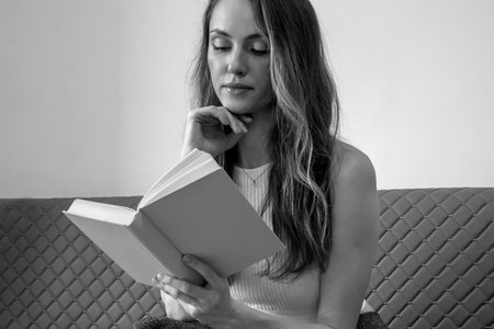 Portrait of a woman reading a book. Black and white photo.の写真素材