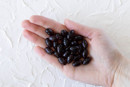 Medication or supplement capsules, Calanus Oil capsules in a womans hand