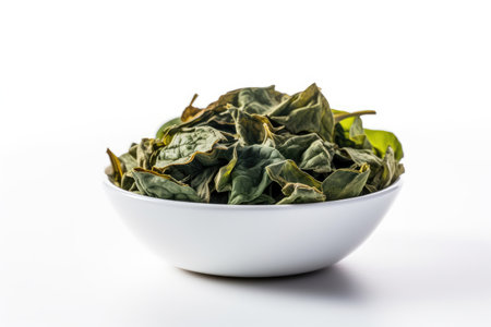 Dried spinach leaves in bowl isolated on white background, healthy nutritionの素材