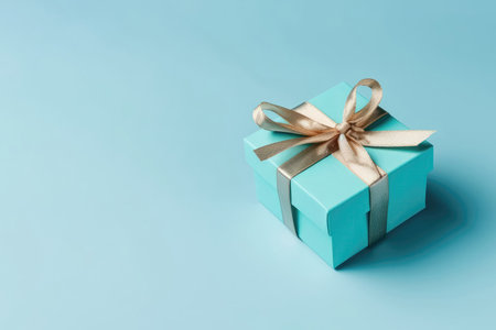 Box With Bow On Sky Blue Color Background, Top View, Copy Spaceの素材