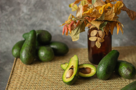 Fresh ripe avocados with leaves and seeds on table, closeupの写真素材