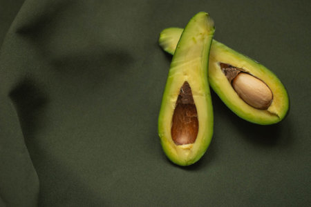 Avocado on a green background. Healthy food concept. Copy space.の写真素材